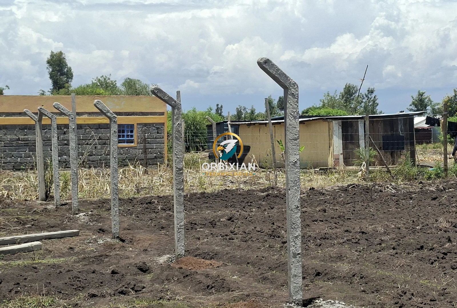 10ft concrete posts being installed for chainlink fence project in Kirinyaga